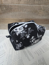 Load image into Gallery viewer, Black floral-patterned bag on a wooden surface with text background
