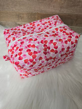 Load image into Gallery viewer, Pink fabric with red heart pattern on a white fur surface