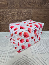 Load image into Gallery viewer, side view of cosmetic bag abstract red and pink poppy flower with black stem on white back ground with white zipper 

