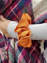 Load image into Gallery viewer, orange scrunchie on wrist 

